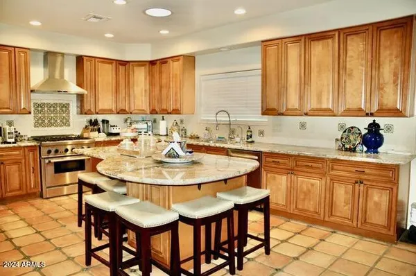 a kitchen with stainless steel appliances kitchen island granite countertop a sink and cabinets