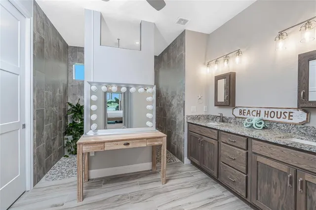 a bedroom with two beds and large windows