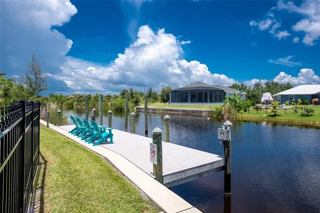 a view of a house with swimming pool and porch with furniture