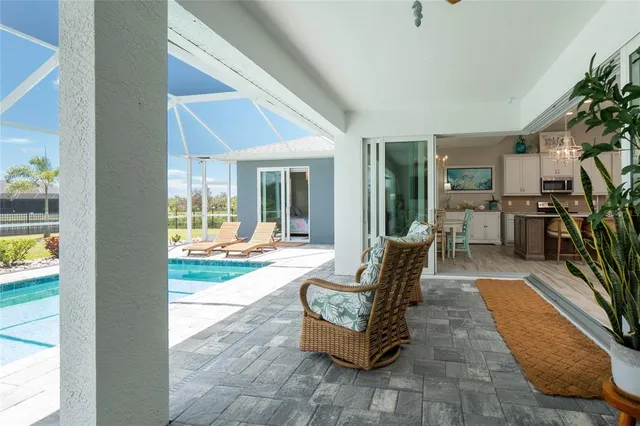 a view of a swimming pool with a table chairs under an umbrella