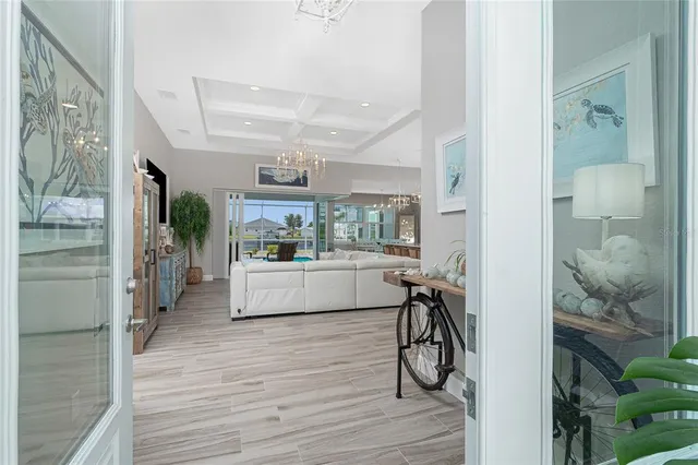 a living room with furniture a flat screen tv and a large window
