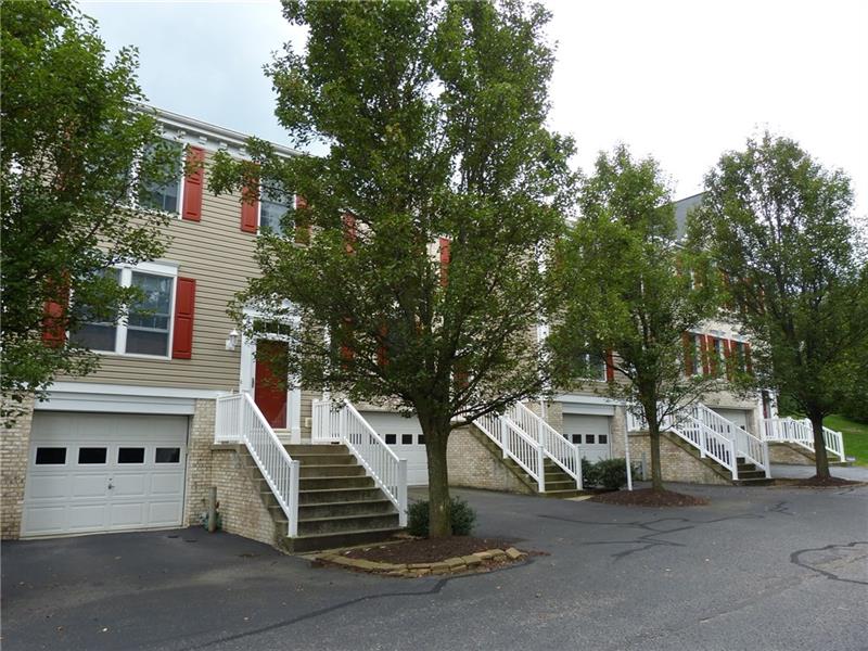 6 Castle View Drive McKees Rocks, PA 15136 - Photo 2 of 25 The full row of townhomes, all well-maintained with curb-appeal. A landscaped area is on the opposite side of the street, offering peace and privacy.