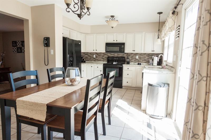 6 Castle View Drive McKees Rocks, PA 15136 - Photo 7 of 25 The updated kitchen features double windows, off-white cabinetry, neutral countertops and a backsplash that runs the perimeter of the huge space.