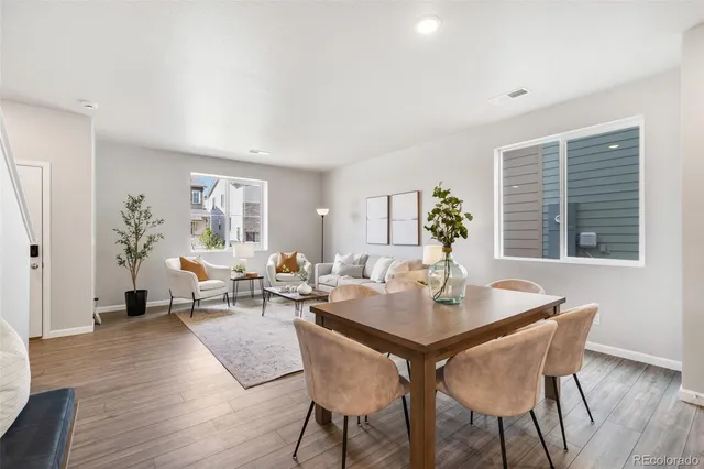 a view of a dining room with furniture window and wooden floor