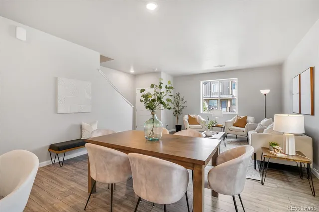 a dining room with furniture and wooden floor