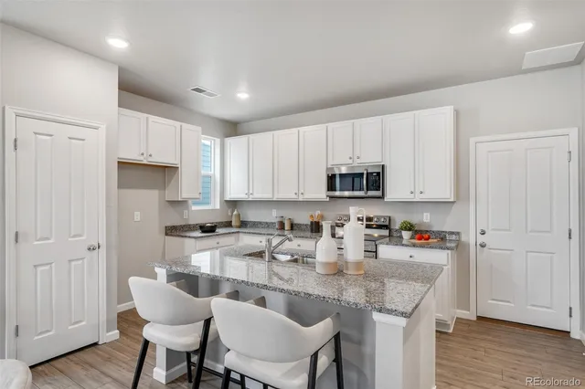 a kitchen with stainless steel appliances granite countertop a sink and cabinets