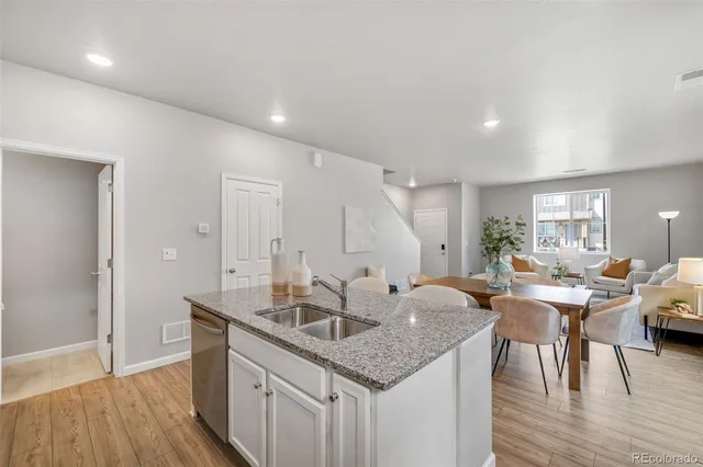 a view of a kitchen area with furniture and wooden floor