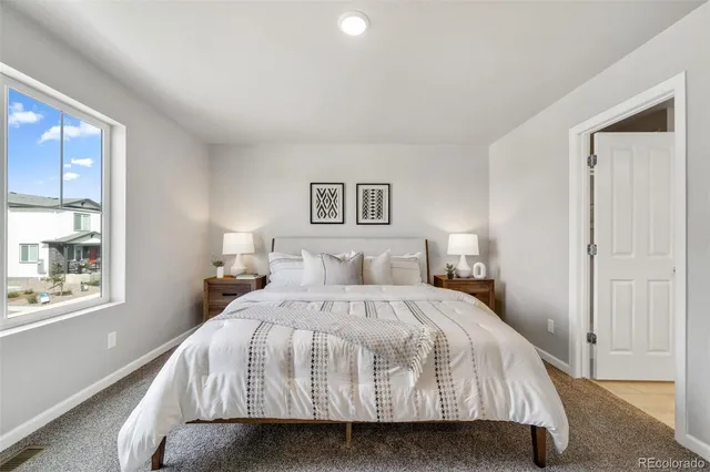 a bedroom with a bed and glass window