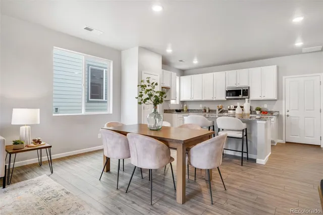 a view of a dining room with furniture and wooden floor