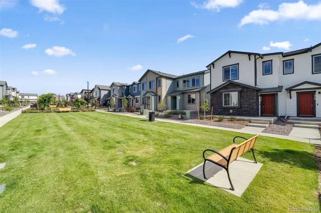 a view of a house with swimming pool and a yard