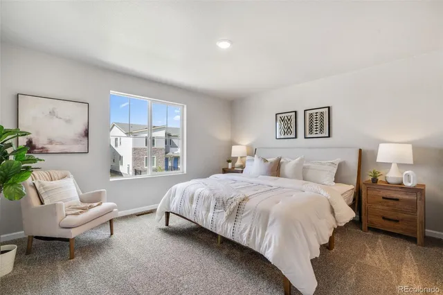 a bedroom with a bed and a couch