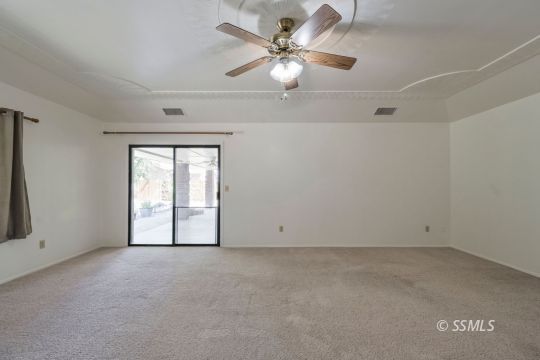 1257 Carolyn Street Ridgecrest, CA 93555 - Photo 27 of 42 an empty room with windows and fan