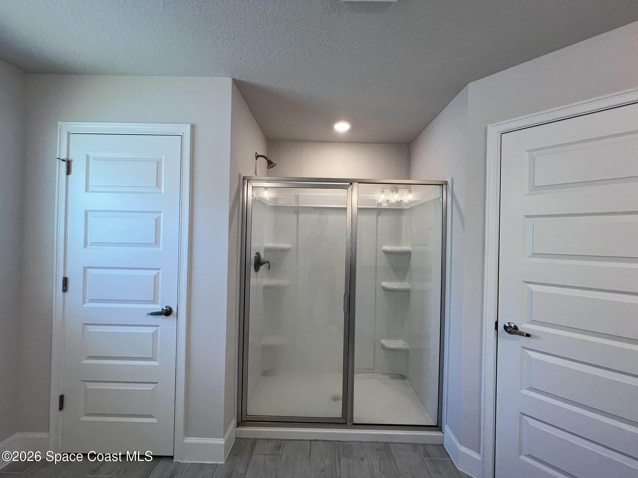8752 Waterstone Boulevard Fort Pierce, FL 34951 - Photo 12 of 24 a bathroom with a glass shower door