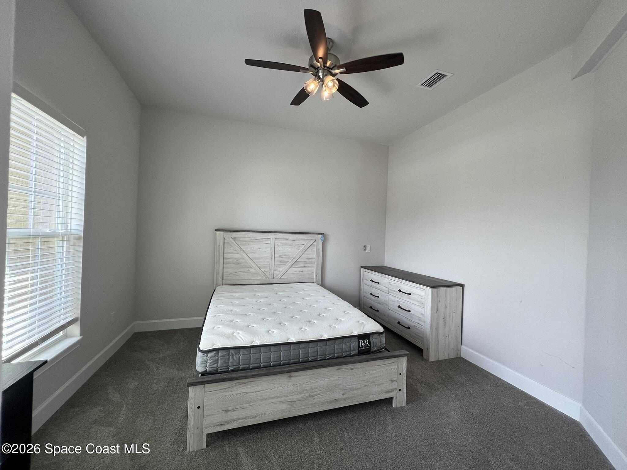 8752 Waterstone Boulevard Fort Pierce, FL 34951 - Photo 14 of 24 a bedroom with a bed and a ceiling fan