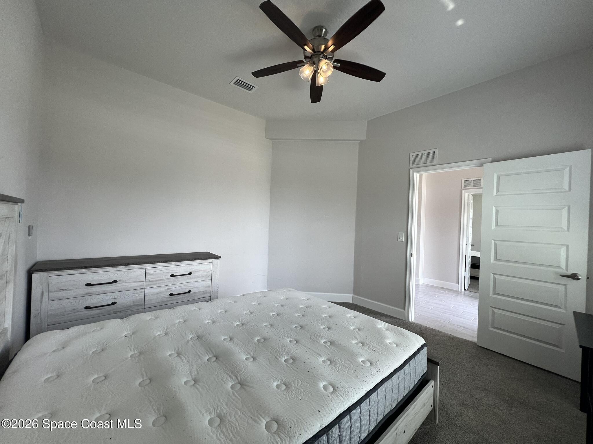 8752 Waterstone Boulevard Fort Pierce, FL 34951 - Photo 15 of 24 a bedroom with a bed and a ceiling fan