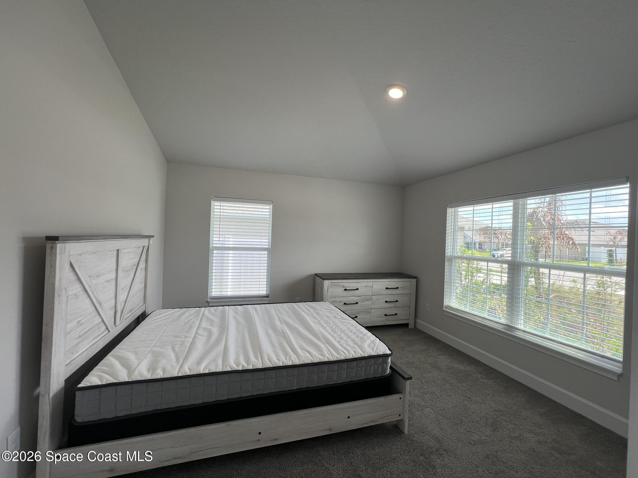 8752 Waterstone Boulevard Fort Pierce, FL 34951 - Photo 16 of 24 a bed sitting in a bedroom next to a window