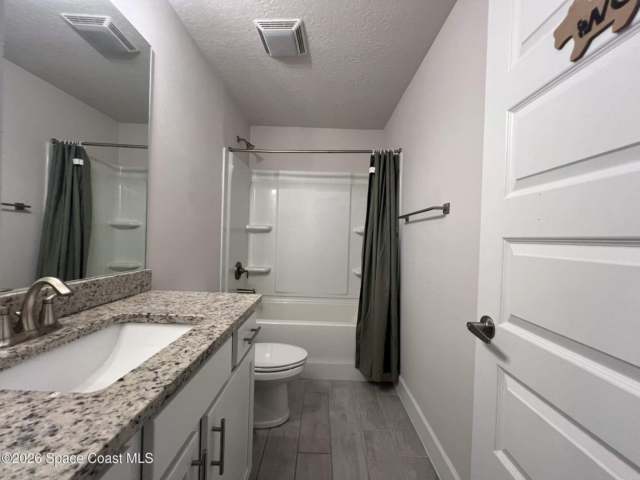 8752 Waterstone Boulevard Fort Pierce, FL 34951 - Photo 19 of 24 a bathroom with a granite countertop sink toilet and shower