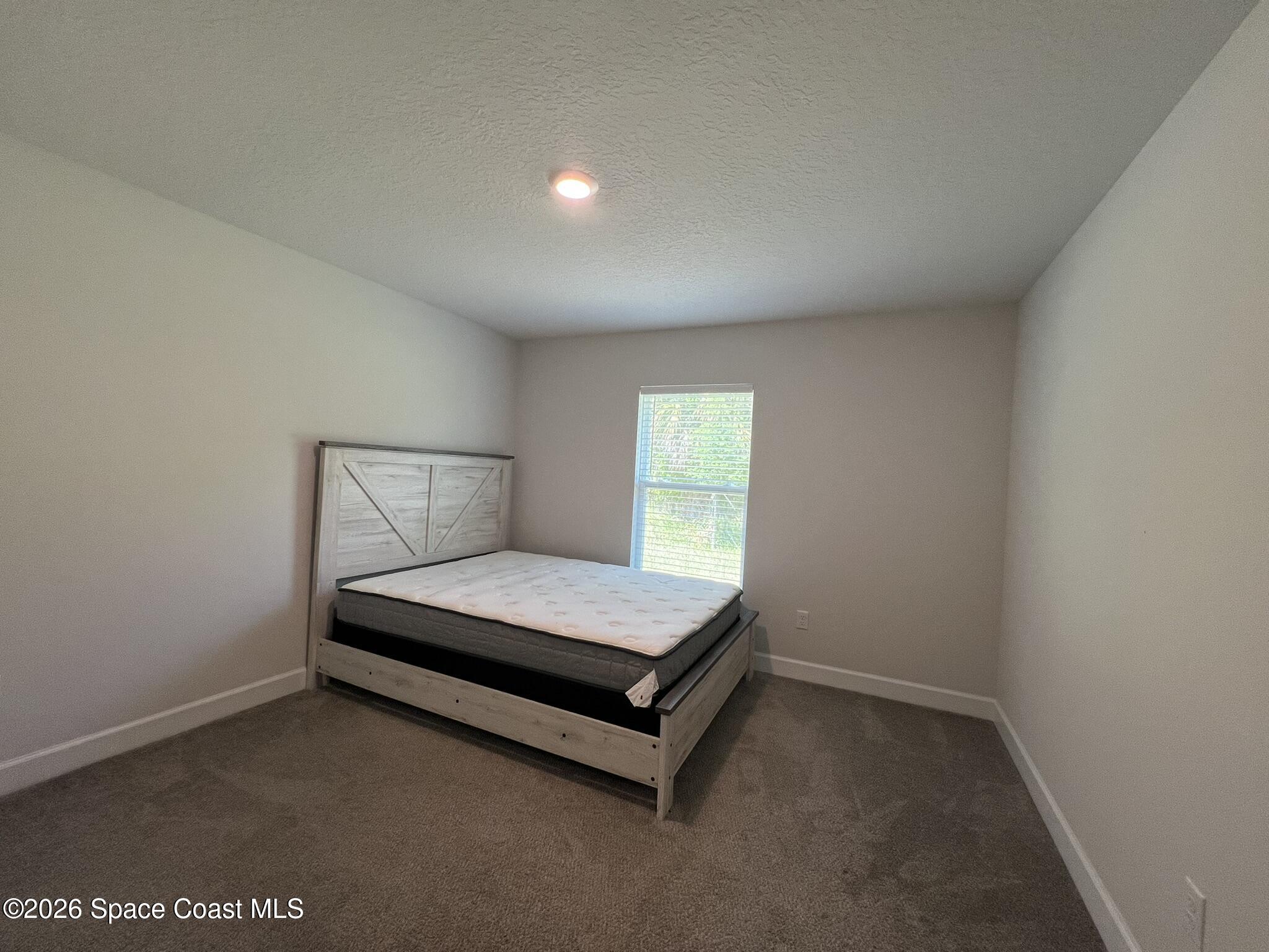 8752 Waterstone Boulevard Fort Pierce, FL 34951 - Photo 20 of 24 a room with a bed