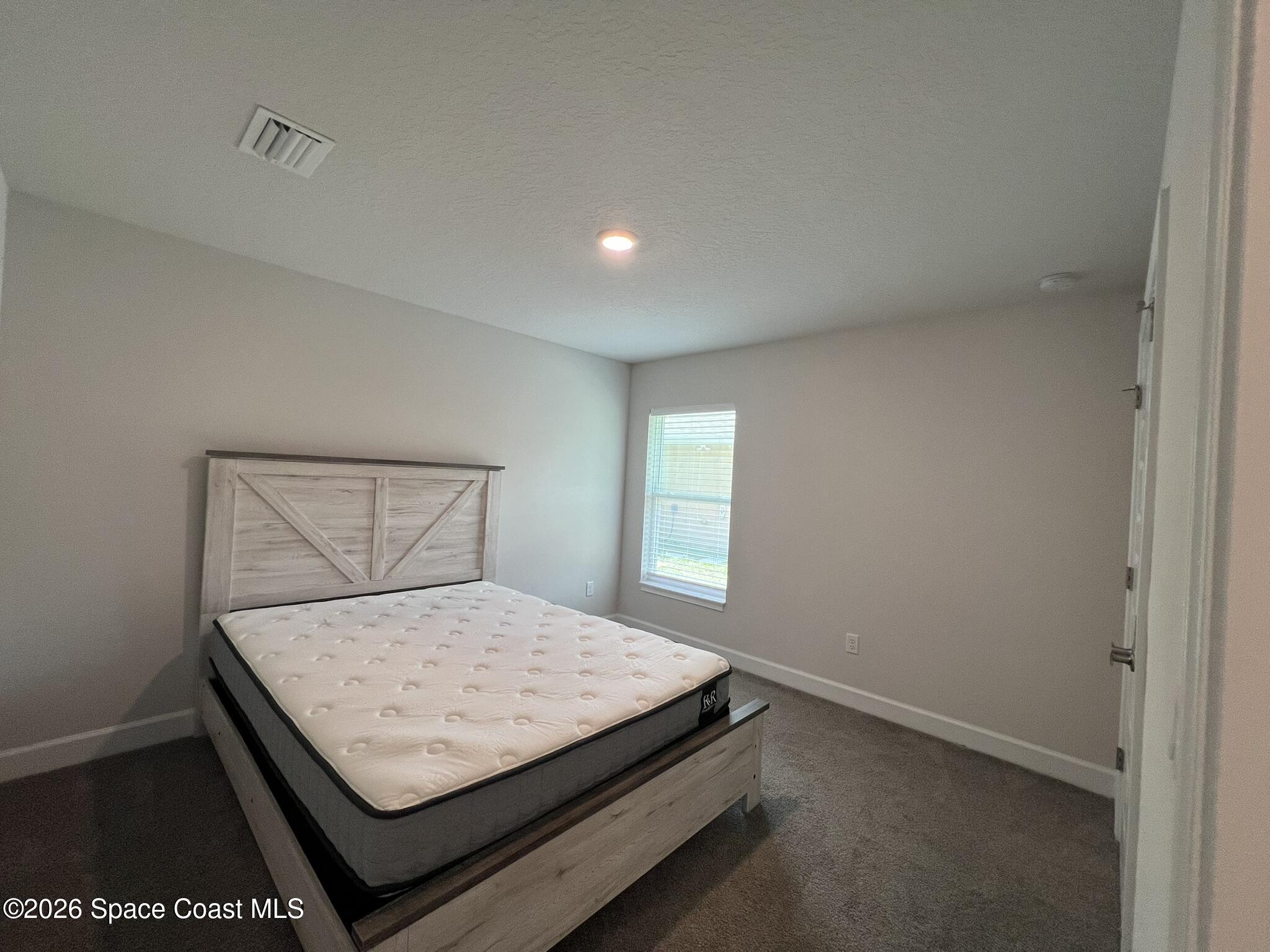 8752 Waterstone Boulevard Fort Pierce, FL 34951 - Photo 21 of 24 a bedroom with a bed and window