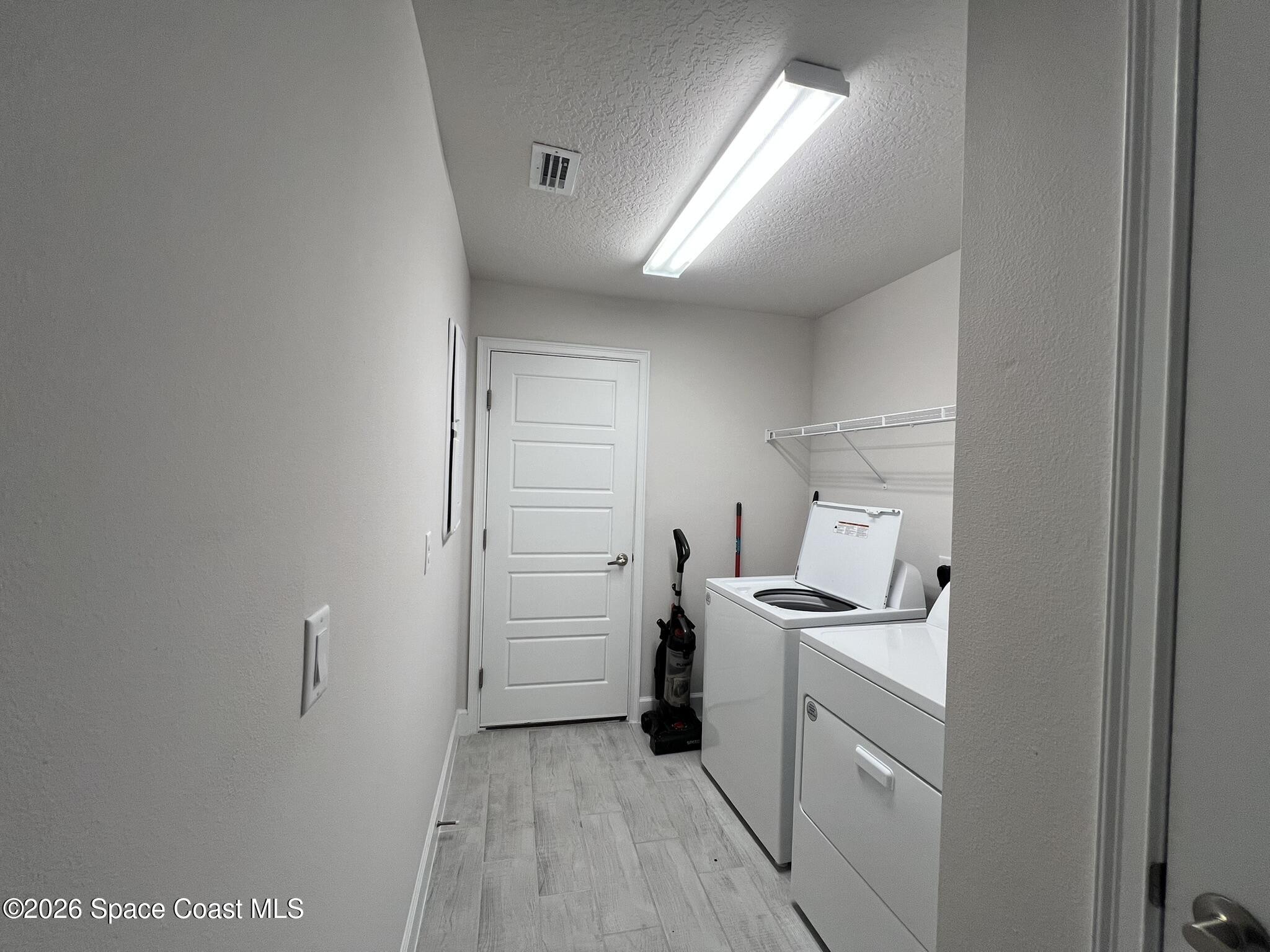 8752 Waterstone Boulevard Fort Pierce, FL 34951 - Photo 23 of 24 a room with storage and utility