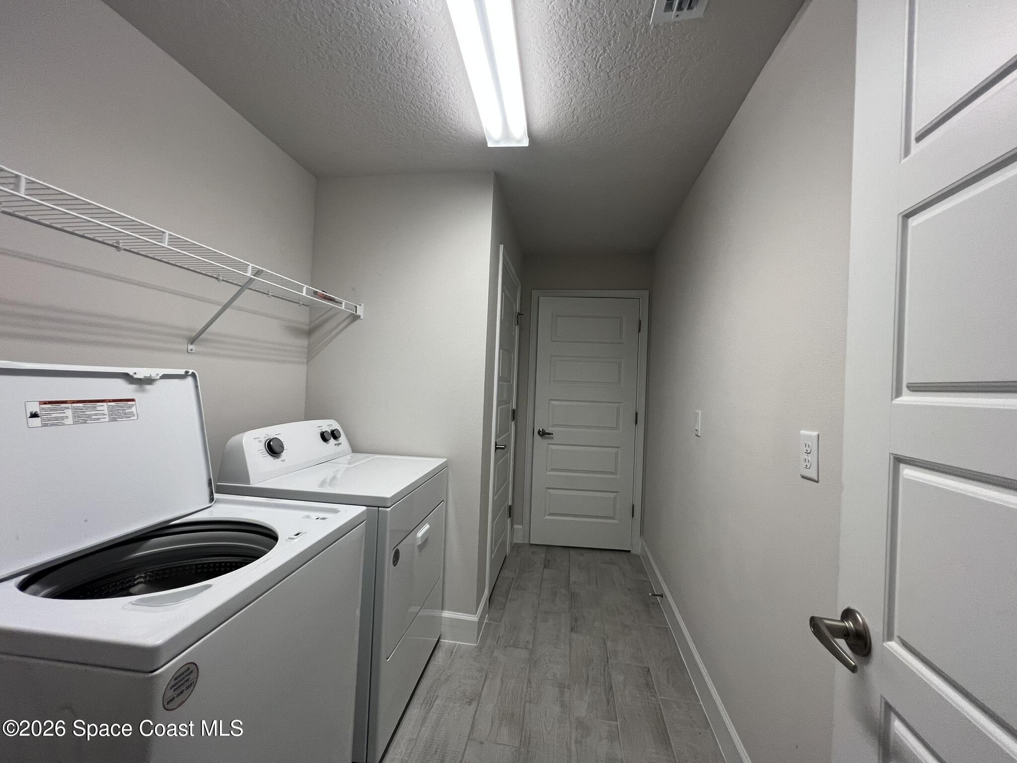 8752 Waterstone Boulevard Fort Pierce, FL 34951 - Photo 24 of 24 a utility room with dryer and washer