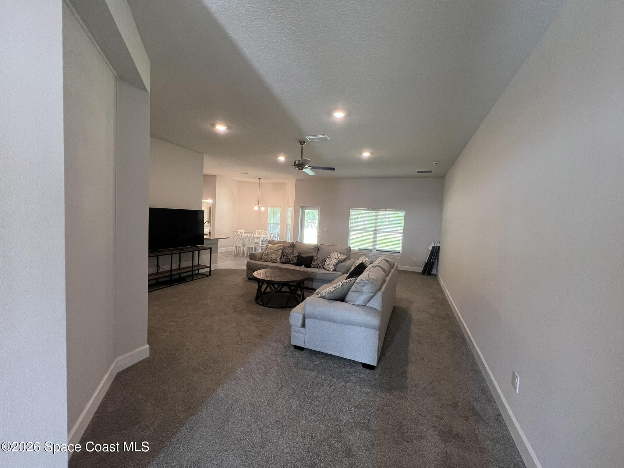 8752 Waterstone Boulevard Fort Pierce, FL 34951 - Photo 3 of 24 a living room with furniture and a flat screen tv