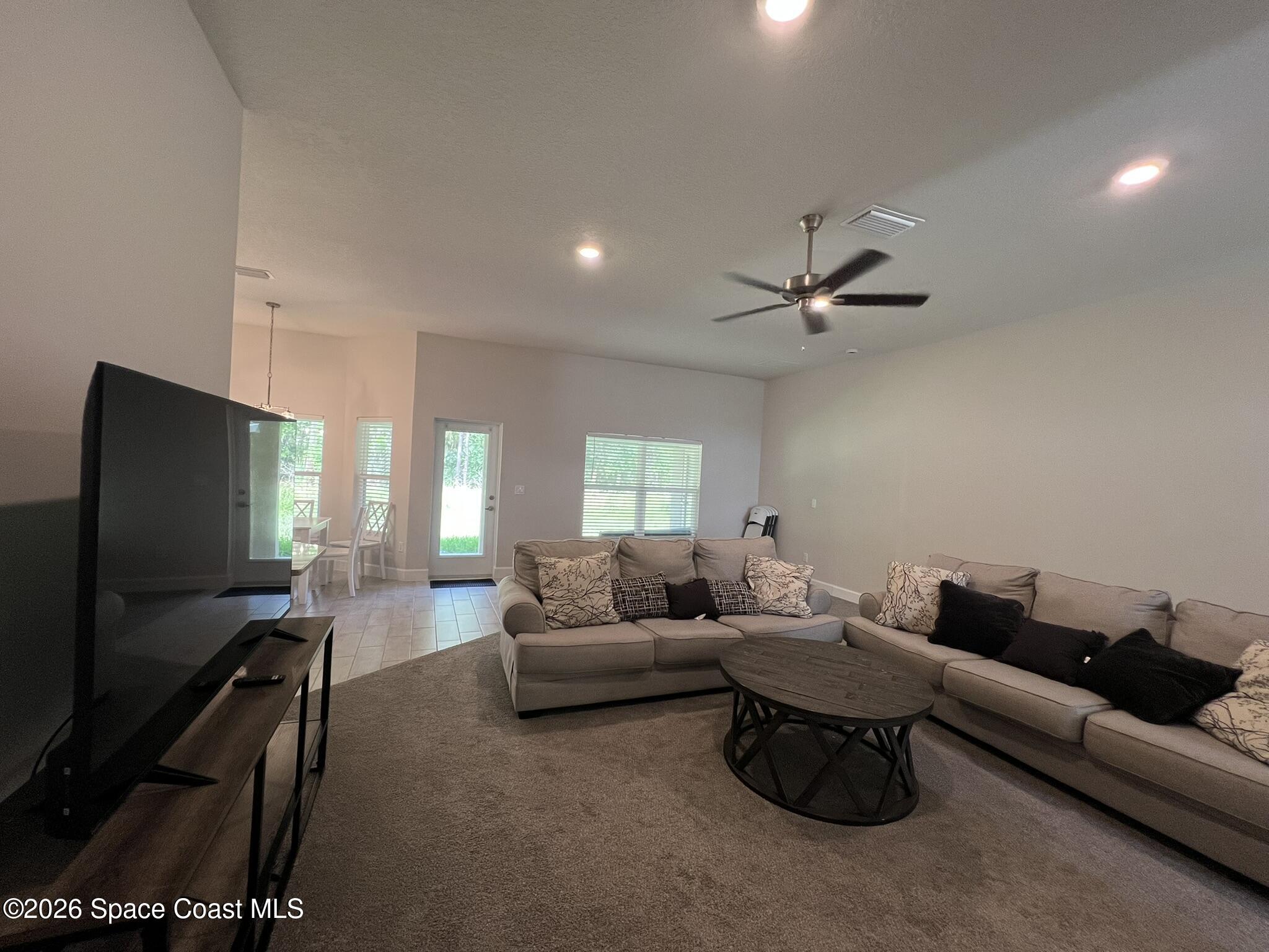 8752 Waterstone Boulevard Fort Pierce, FL 34951 - Photo 4 of 24 a living room with furniture and a flat screen tv