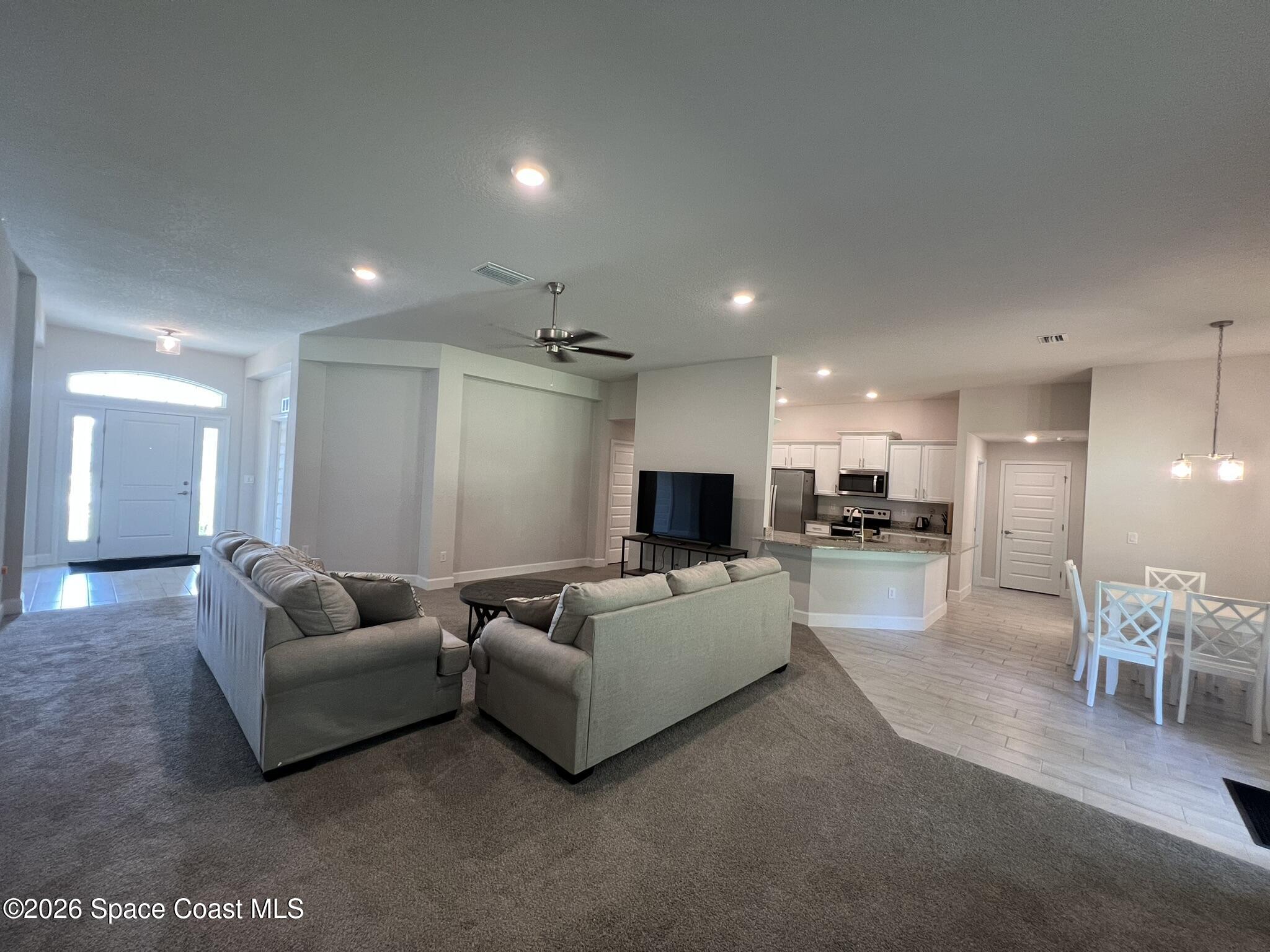 8752 Waterstone Boulevard Fort Pierce, FL 34951 - Photo 5 of 24 a living room with furniture and a flat screen tv