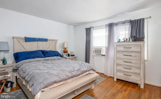 a bed sitting in a bedroom next to a window with dresser