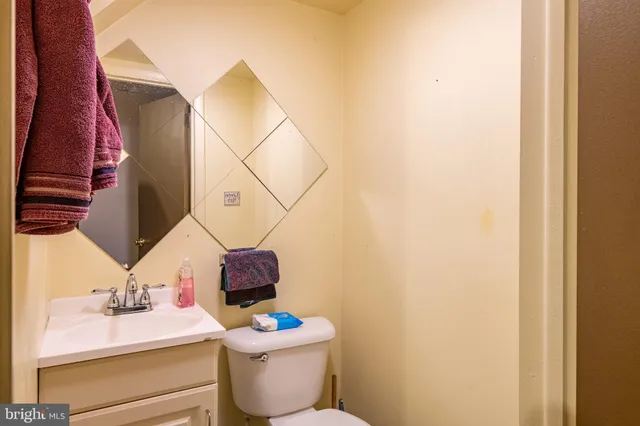 a bathroom with a sink toilet and mirror