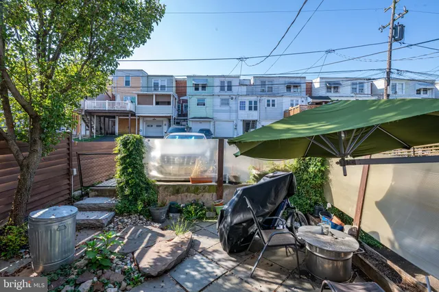 a view of a patio with table and chairs potted plants