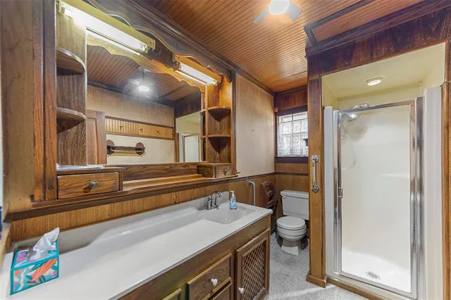an empty room with windows and chandelier fan
