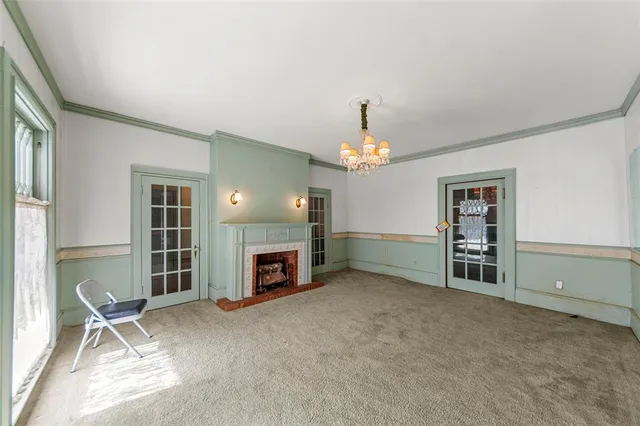 a view of a livingroom with a fireplace a window and a fireplace