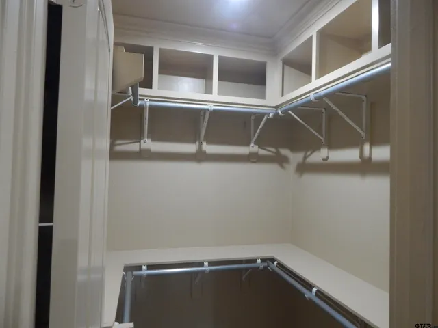 a view of storage and utility room with racks on the wall