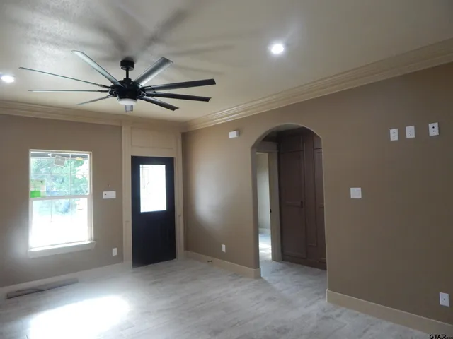 a view of a livingroom with a ceiling fan and window