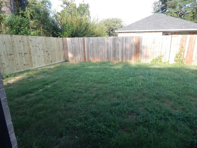a view of a backyard with a small cabin and a chair