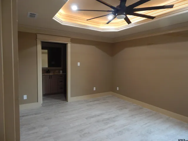 a view of empty room with wooden floor and entryway