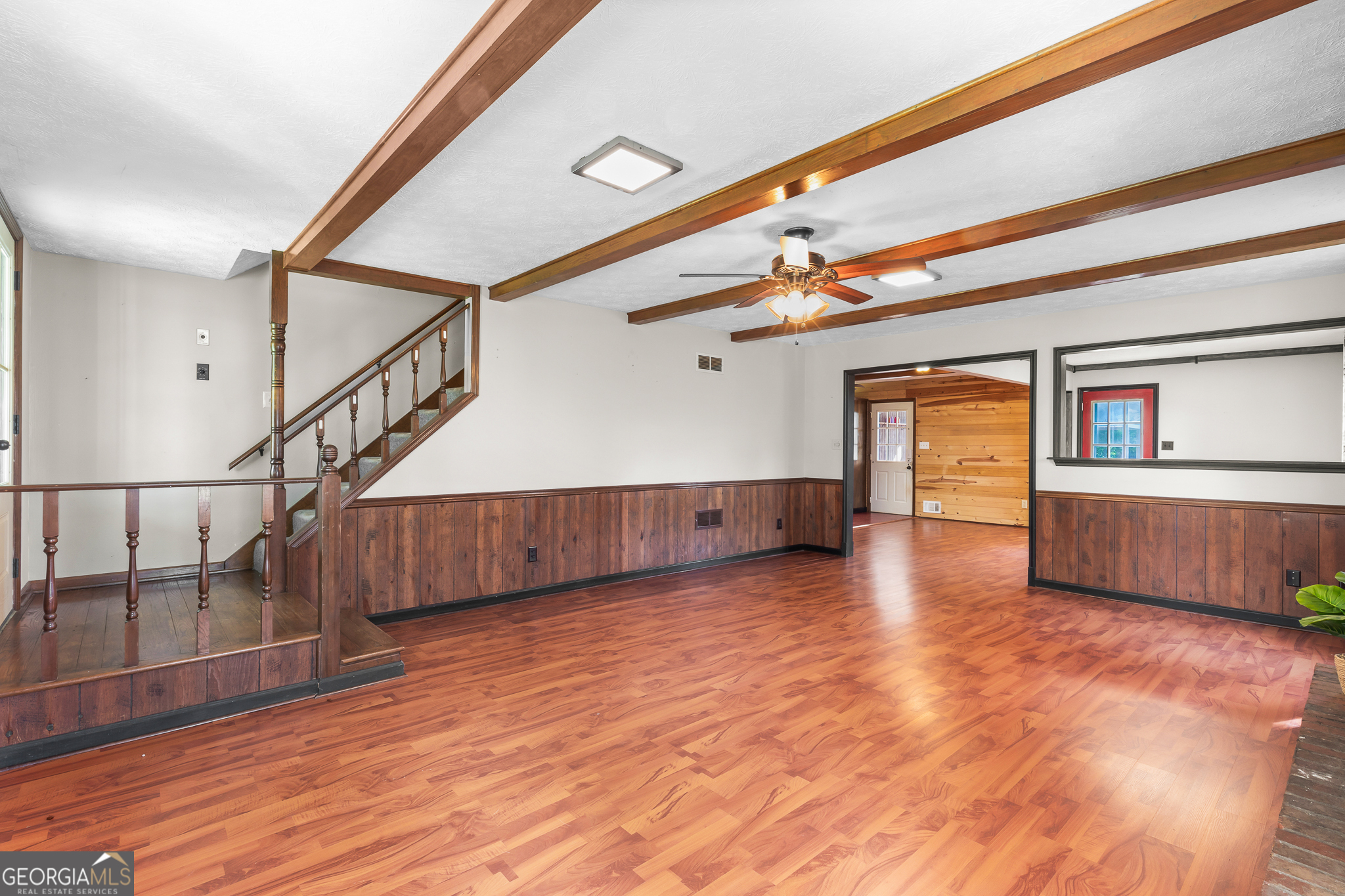 4170 Hollonville Road Williamson, GA 30292 - Photo 11 of 132 a view of a livingroom with wooden floor and stairs