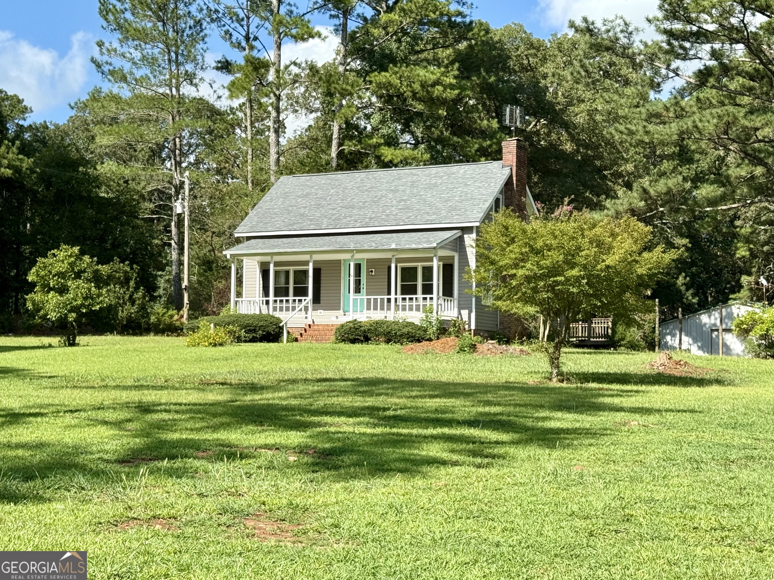 4170 Hollonville Road Williamson, GA 30292 - Photo 112 of 132 a front view of a house with a yard table and chairs
