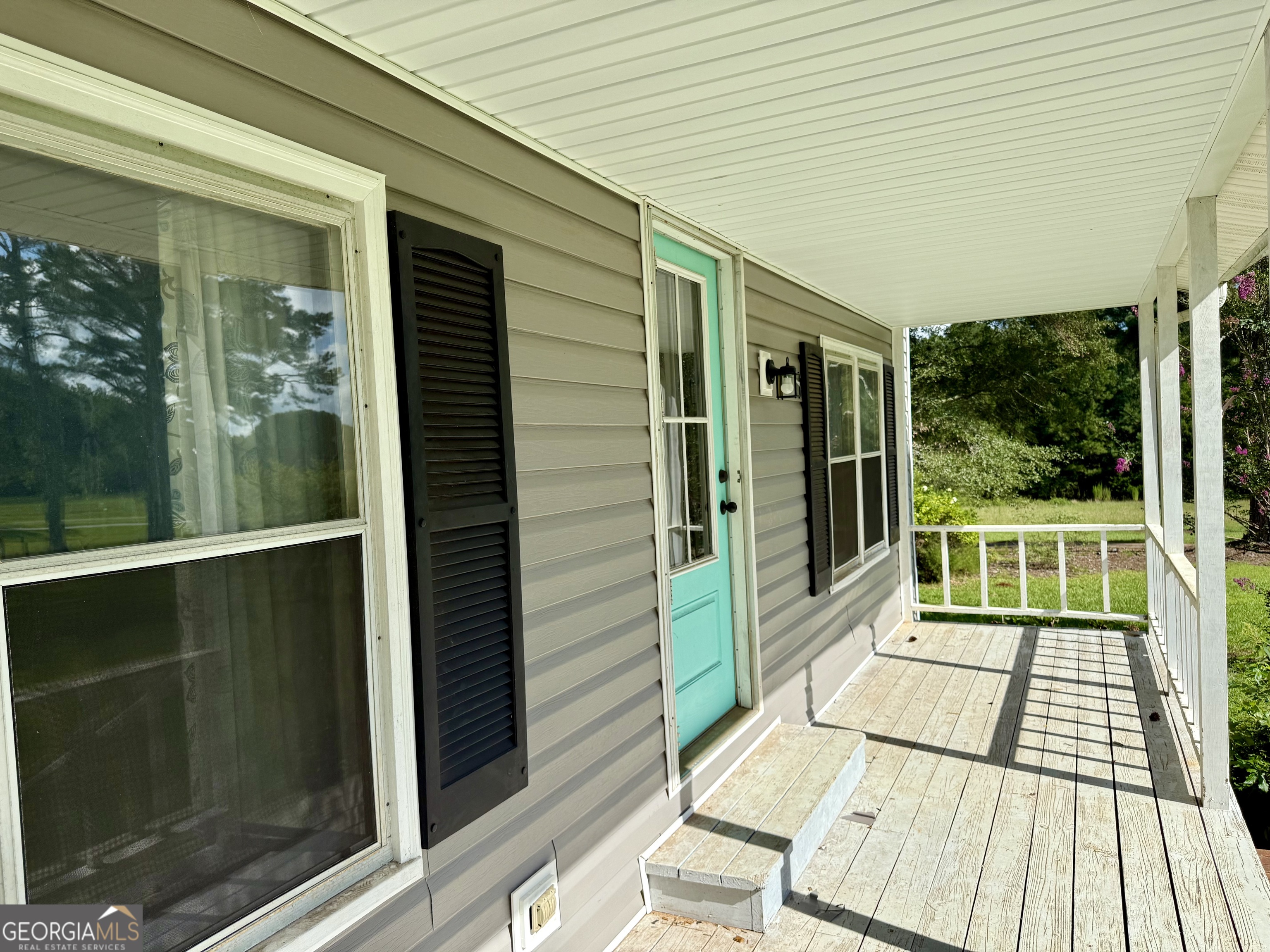 4170 Hollonville Road Williamson, GA 30292 - Photo 127 of 132 a view of a balcony with wooden floor