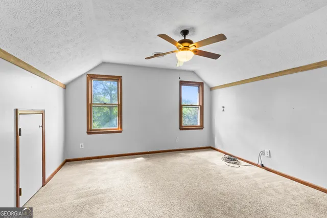 a view of a yard with wooden fence