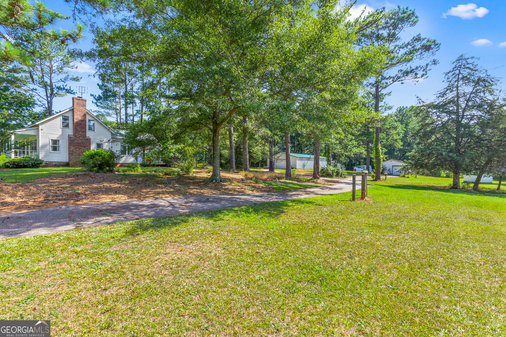 4170 Hollonville Road Williamson, GA 30292 - Photo 31 of 132 a backyard of a house with lots of green space and fountain