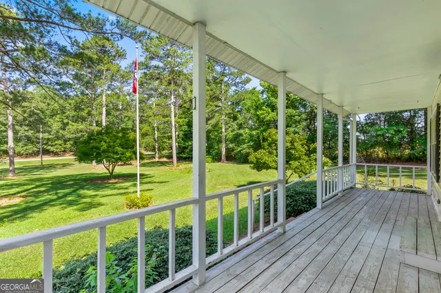a view of an entryway with wooden floor fireplace and windows