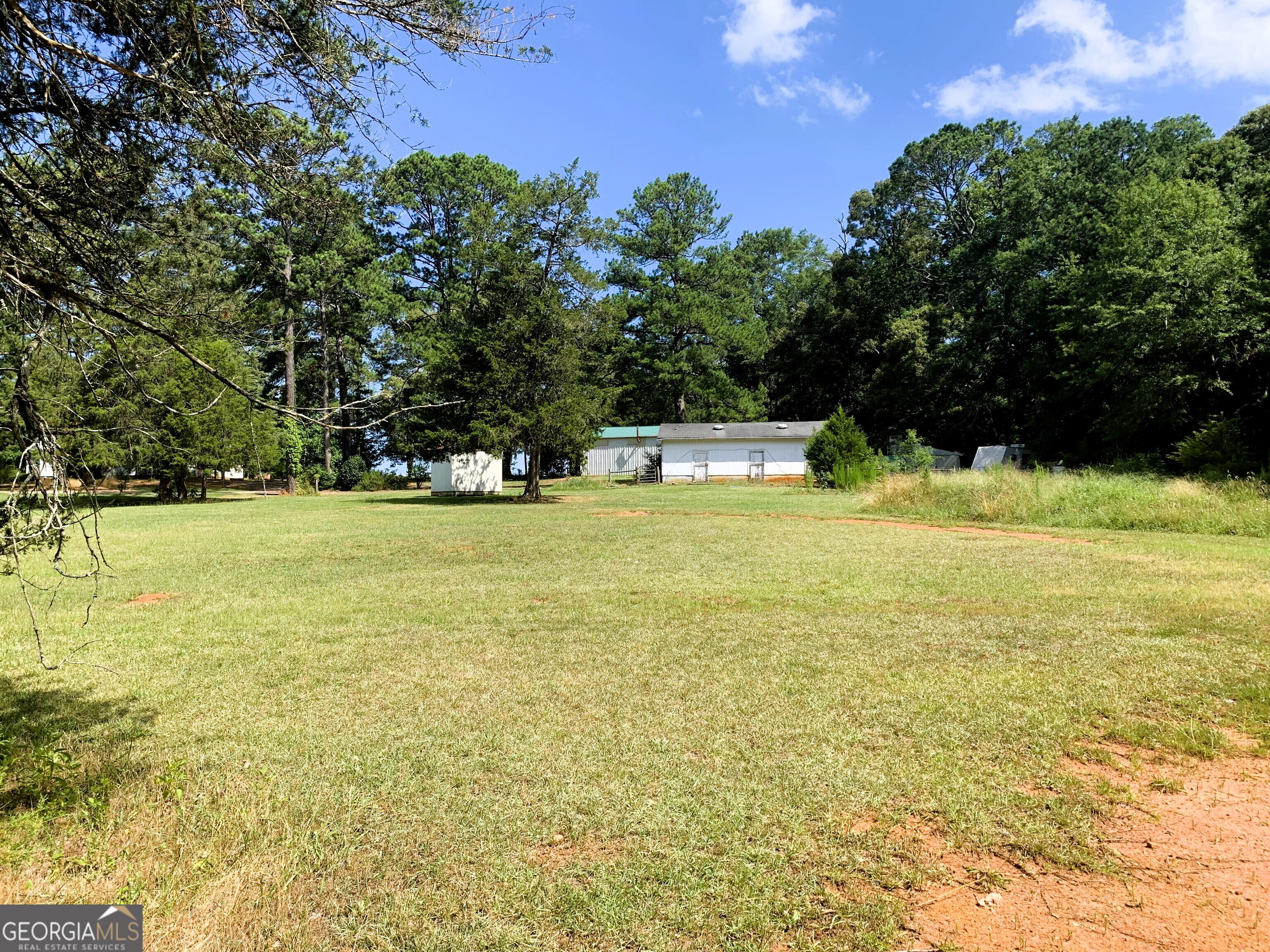 4170 Hollonville Road Williamson, GA 30292 - Photo 65 of 132 a view of a swimming pool with an outdoor space and seating area