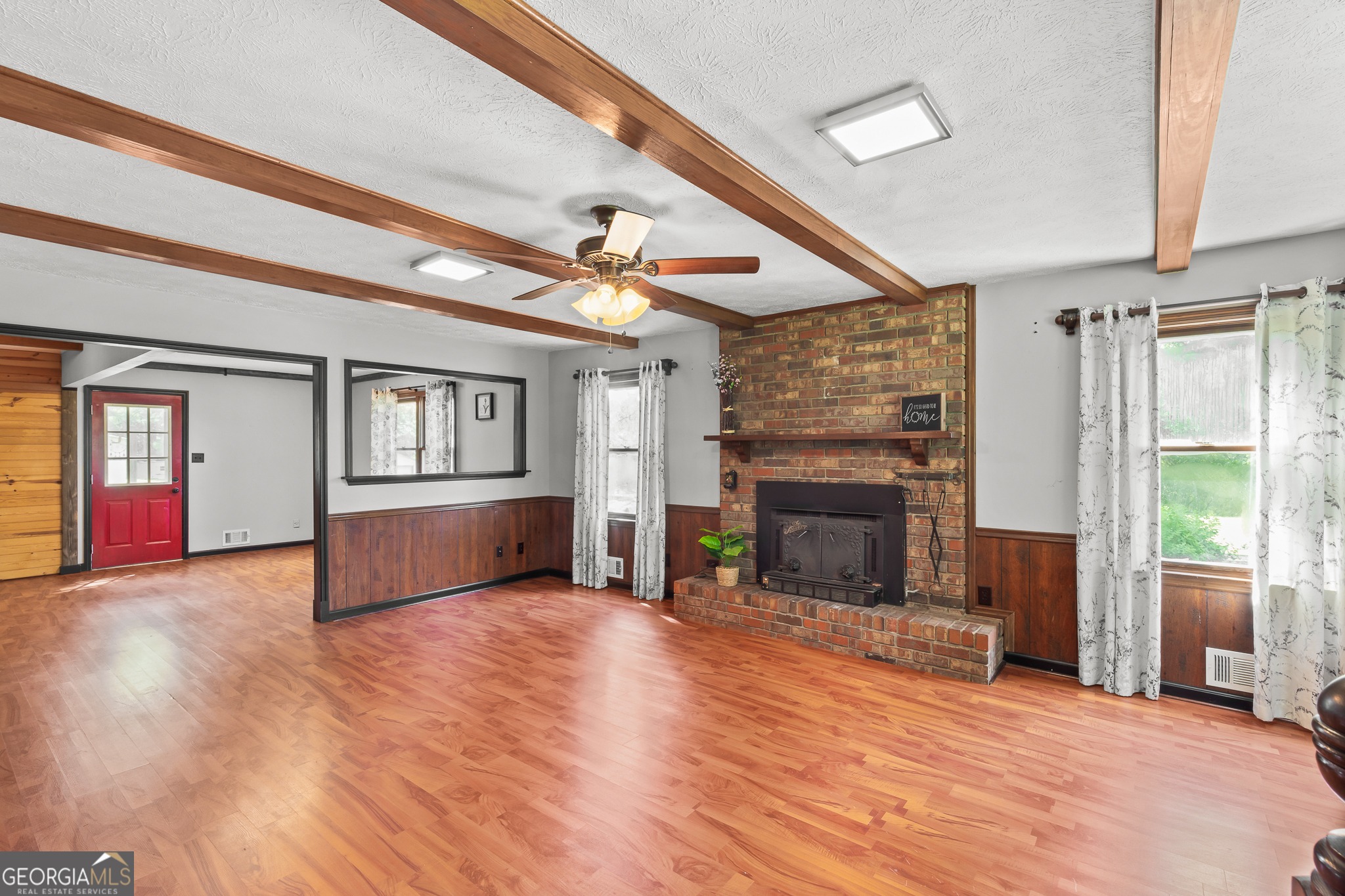 4170 Hollonville Road Williamson, GA 30292 - Photo 10 of 132 a view of livingroom with fireplace wooden floor and window