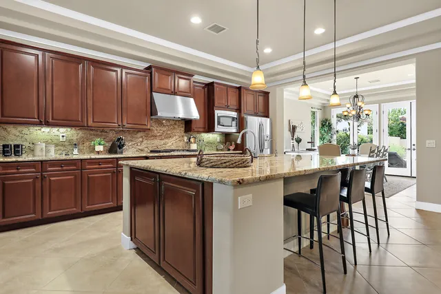 a kitchen with granite countertop a sink and cabinets