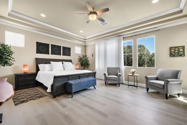 a bedroom with a bed a flat screen tv and a couch