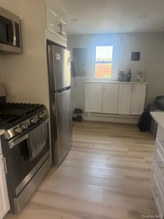 a kitchen with stainless steel appliances granite countertop a refrigerator stove and sink