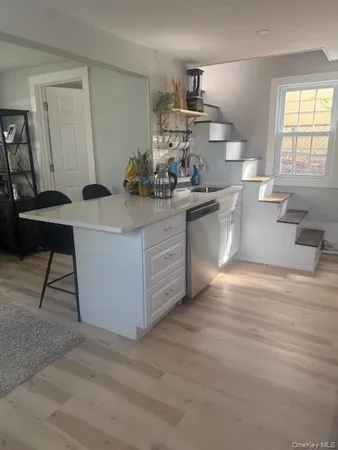 a kitchen with a sink cabinets and window