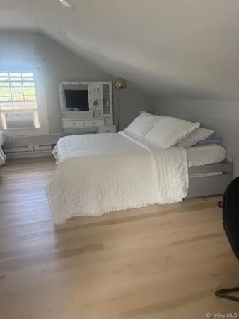 a spacious bedroom with a bed and window